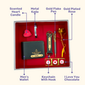 A box showcasing customized leather wallet, keychain, gold flaked pen, metal kada, scented candle with a gold plated rose and higlighting their features. Perfect for valentines gifting.