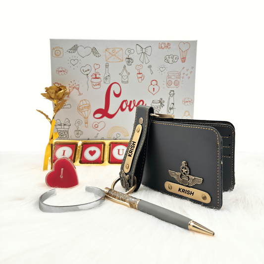 A customized grey leather wallet, grey keychain, gold flaked pen, metal kada, scented candle with a gold plated rose, enclosed in a white box, perfect for valentines gifting.