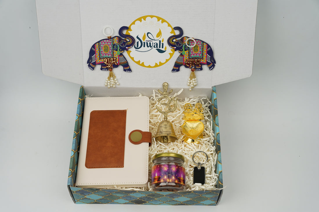 "Personalized Diwali Gift Hamper 2.0-WHITE “Dual Shade Diary, Metal Keychain, Om Brass Bell, Laxmi Ganesh Diya, Almond Jar & Shubh Labh Latkan – Festive Gift Box”