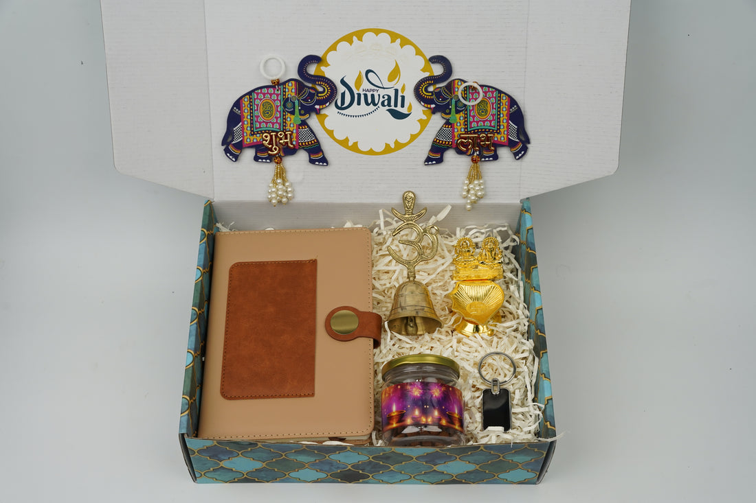 "Personalized Diwali Gift Hamper 2.0-TANN“Dual Shade Diary, Metal Keychain, Om Brass Bell, Laxmi Ganesh Diya, Almond Jar & Shubh Labh Latkan – Festive Gift Box”
