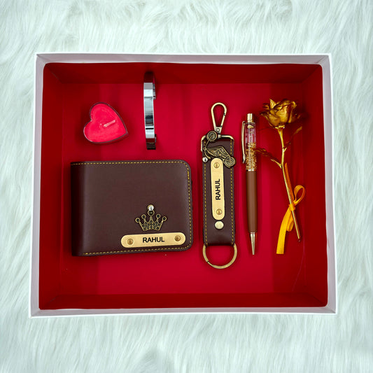 A top view of a box containing customized brown leather wallet, keychain, gold flake pen, kada, scented candle and gold plated rose.