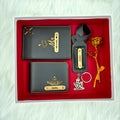 A top view of a box containing customized grey leather wallet, passport cover, luggage tag, I Love You keychain, and gold plated rose.