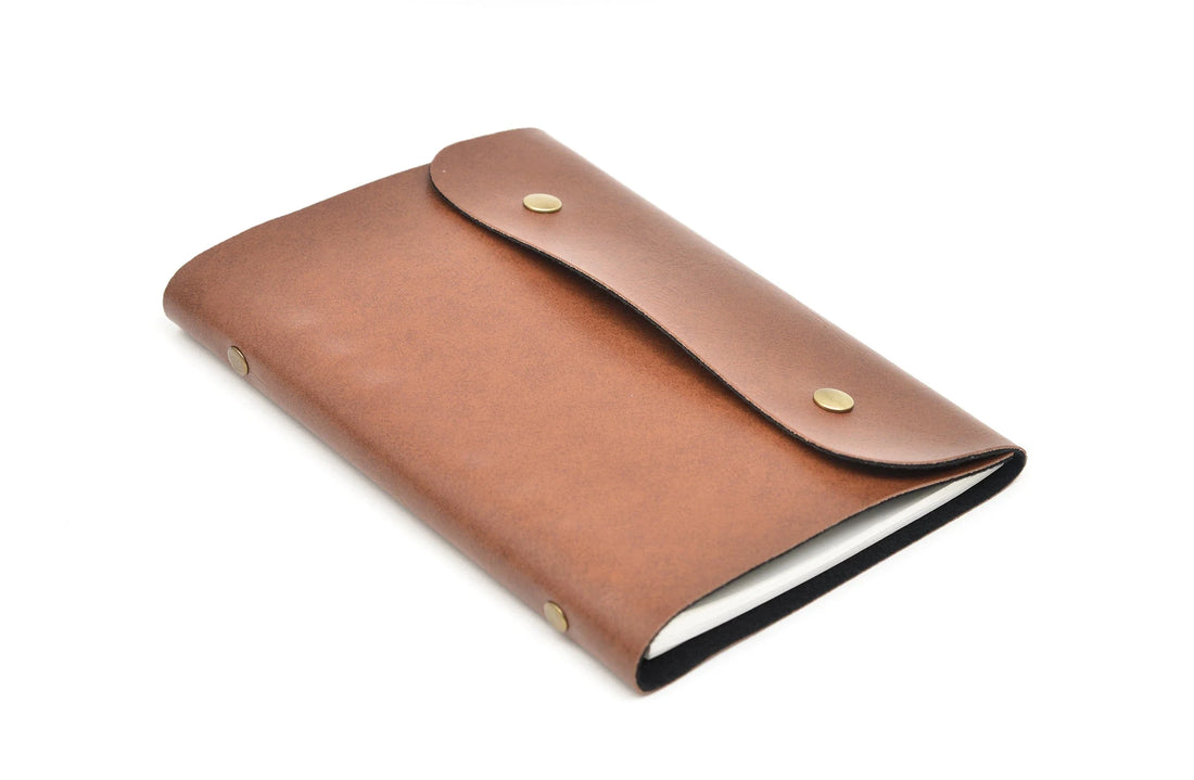 Our custom leather buttoned diaries are designed to meet the needs of the modern professional. With multiple compartments and a sleek design, it's the perfect way to stay organized and stylish.