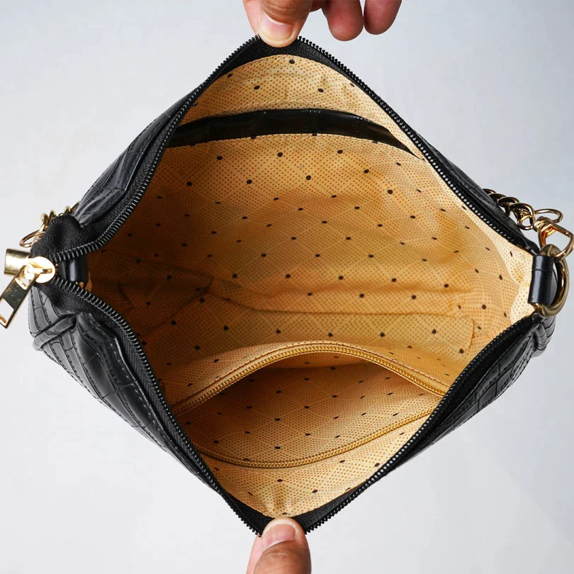 inside or open view of croc sling bag- black