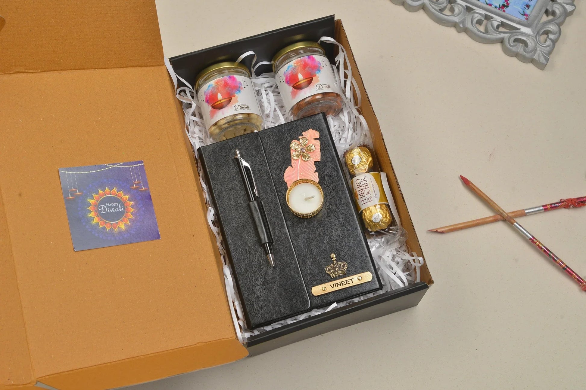 Celebrate the festive season with our Diwali Combo! This set features a stylish diary, a useful keychain, a beautiful diya, delicious chocolates, a sleek pen, and a handy dry fruit jar. The perfect gift for friends and family!