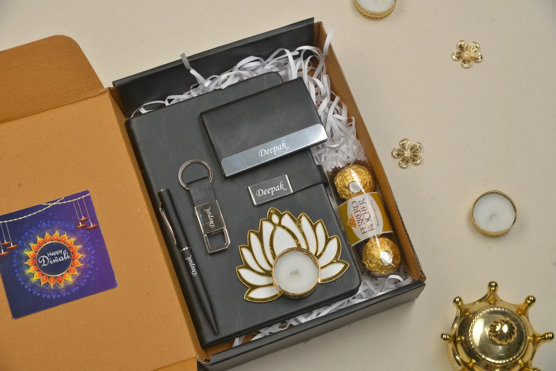 Gift the gift of organization, style, and tradition this Diwali with our Diwali combo set. This set includes a beautifully designed diary for capturing your thoughts and memories, a stylish keychain for everyday use, a traditional diya for spreading light and joy, delicious chocolates to treat your taste buds, and a high-quality pen to write it all down.