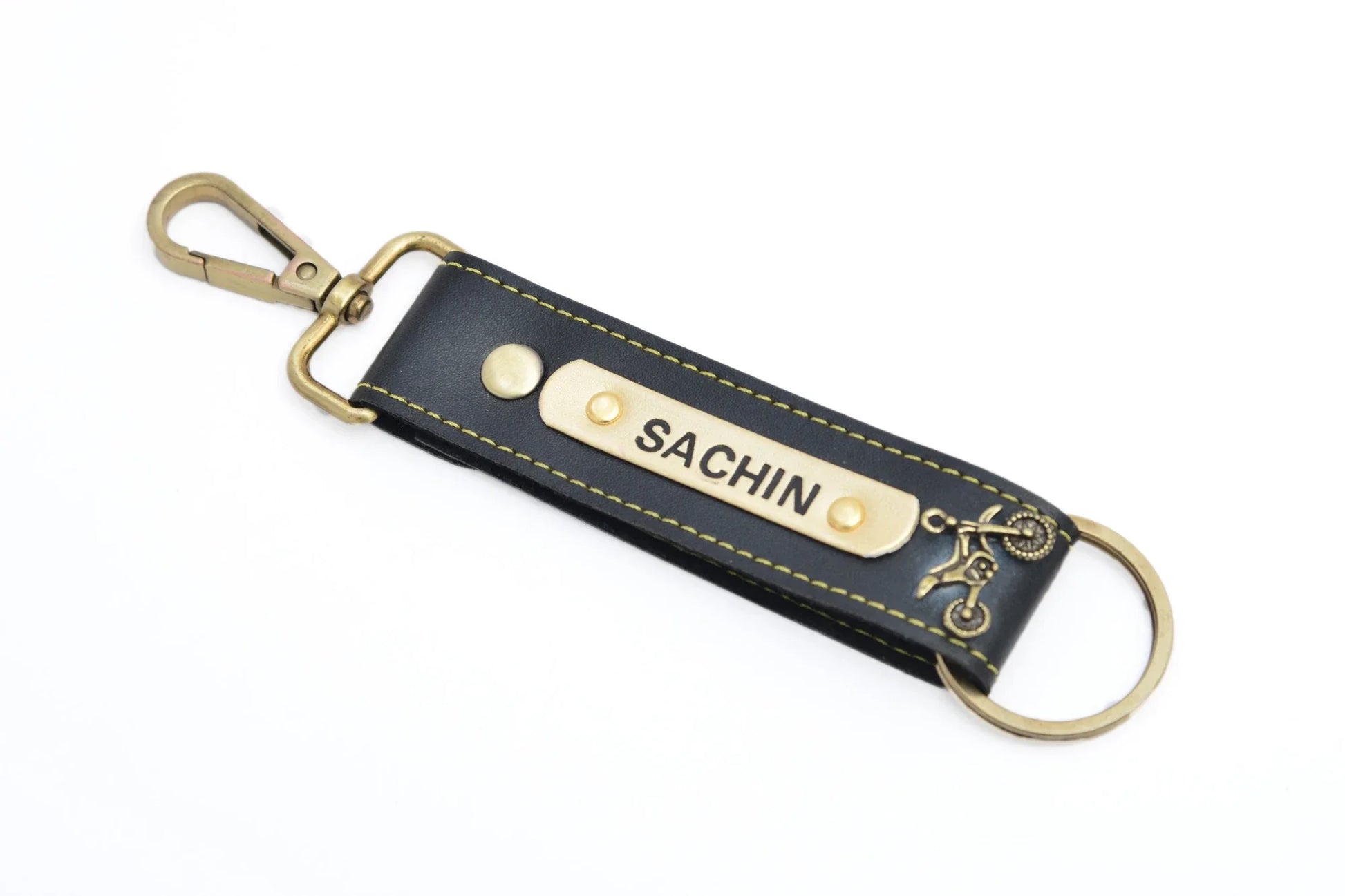 In a bundle of keys, let this personalized faux leather keychain mark the elegance of your keys with your name and favourite trinket on it.