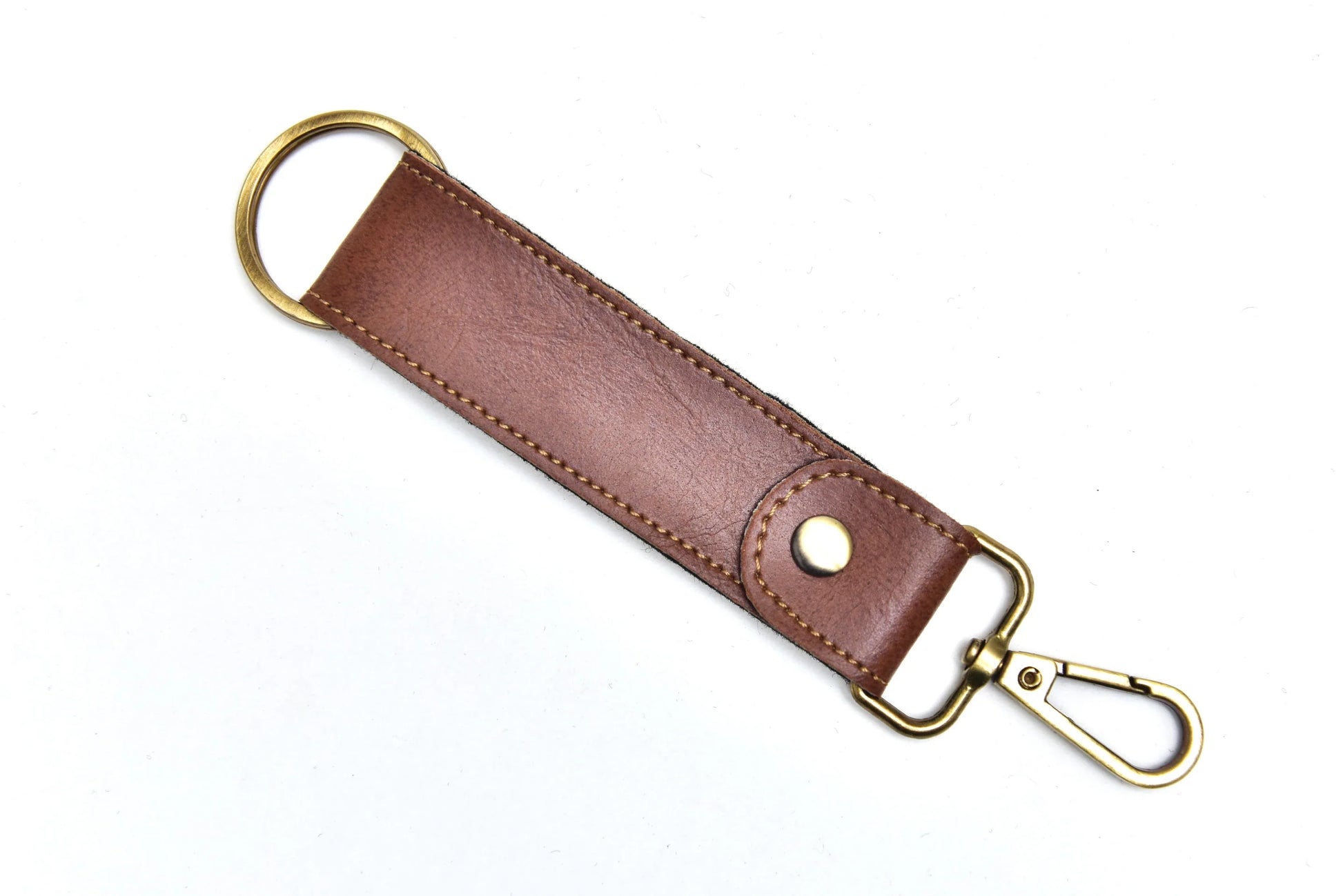 "The sleek, modern design of this leather keychain adds a touch of sophistication to your everyday carry. "